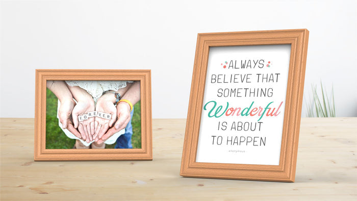 Two beech picture and poster frames displaying a photo and inspirational quote on a wooden surface.