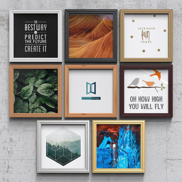 Various silver picture and poster frames showcasing different artwork and designs on a textured wall background.