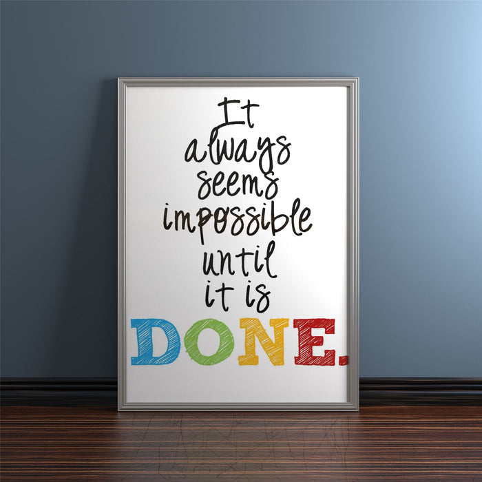 Silver picture and poster frames showcasing an inspirational quote: 'It always seems impossible until it is DONE.'
