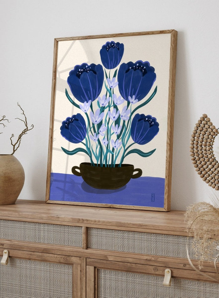 Artistic depiction of blue flowers in a black pot on a beige background. Blue Floral Arrangement by Dirkie Nell is a botanical floral art print featuring deep blue flowers, folk inspired illustration, modern wall art, and expressive hand painted details.