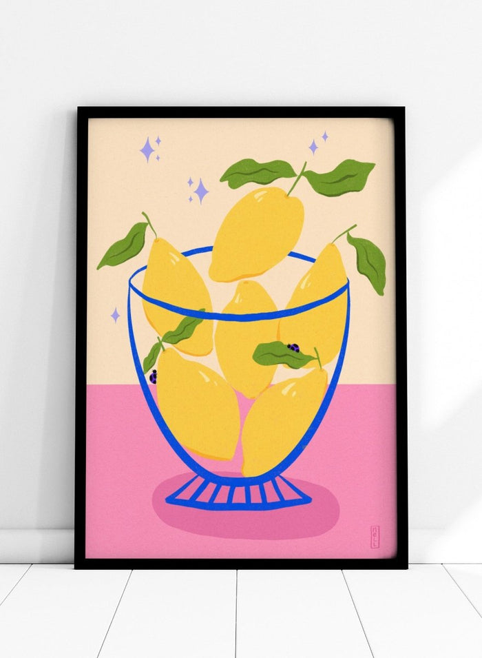 Illustration of lemons in a glass bowl with green leaves on a pink and beige background. Blue Floral Arrangement by Dirkie Nell is a botanical floral art print featuring deep blue flowers, folk inspired illustration, modern wall art, and expressive hand painted details.