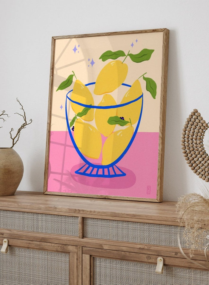Illustration of lemons in a glass bowl with green leaves on a pink and beige background. Blue Floral Arrangement by Dirkie Nell is a botanical floral art print featuring deep blue flowers, folk inspired illustration, modern wall art, and expressive hand painted details.