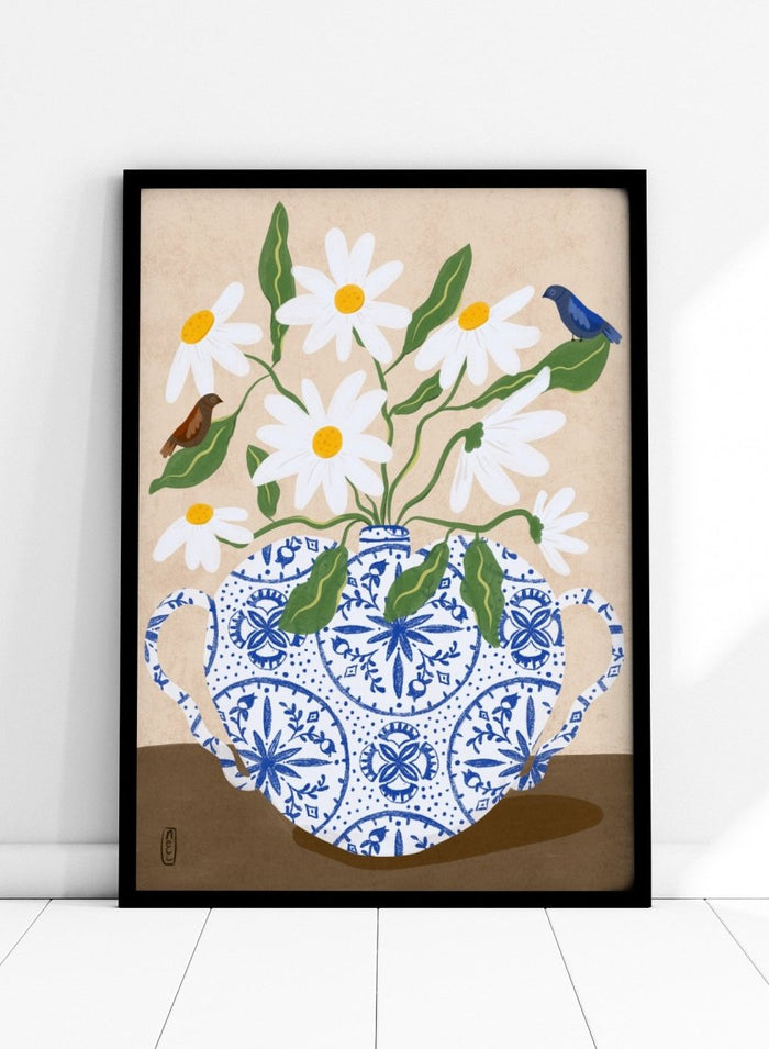 Decorative illustration of a blue and white teapot with daisies and birds on a beige background. Daisies In Blue Teapot by Dirkie Nell is a floral art print featuring white daisies, blue pottery, birds, and hand painted botanical details.