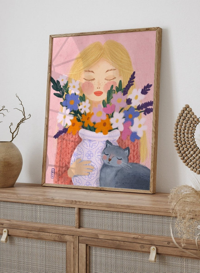 Illustration of a woman holding a vase of flowers and a cat on a pink background. Dreamy Girl Cat Flowers by Dirkie Nell is a colorful floral portrait art print featuring hand painted flowers, a sleepy cat, and soft contemporary illustration details.