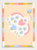 A framed art print featuring a whimsical illustration of a white dove with blue flowers and a pink heart, framed by a pastel multicolor border on a light peach background. Shop Flowering Peace Dove by Dirkie Nell, a colorful bird and floral art print featuring a white dove, blue flowers, pink wings, and a playful peace motif.