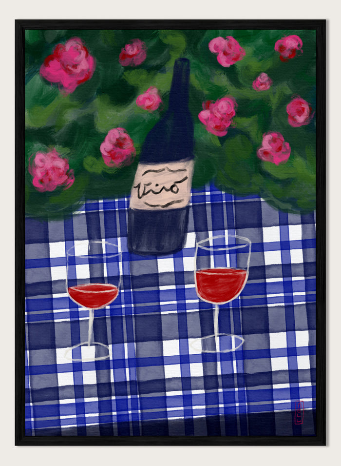 A painted still life scene featuring a dark wine bottle labeled 'vino' on a blue-and-white plaid tablecloth, with two glasses of red wine and pink flowers against a green background. Shop Garden Wine Picnic by Dirkie Nell, a colorful still life art print featuring red wine, blue gingham, pink roses, and a warm summer garden mood.
