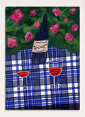 A painted still life scene featuring a dark wine bottle labeled 'vino' on a blue-and-white plaid tablecloth, with two glasses of red wine and pink flowers against a green background. Shop Garden Wine Picnic by Dirkie Nell, a colorful still life art print featuring red wine, blue gingham, pink roses, and a warm summer garden mood.