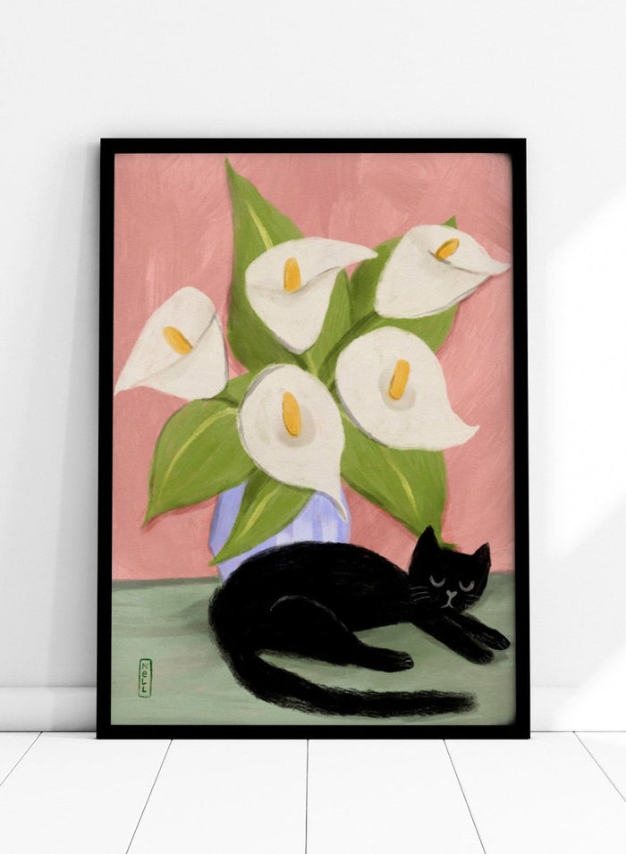 Black cat lying on a surface with white flowers in a blue vase against a pink background. Lilies In a Vase and a Black Cat by Dirkie Nell is a contemporary floral cat art print featuring hand painted lilies, soft pink tones, and playful still life illustration.