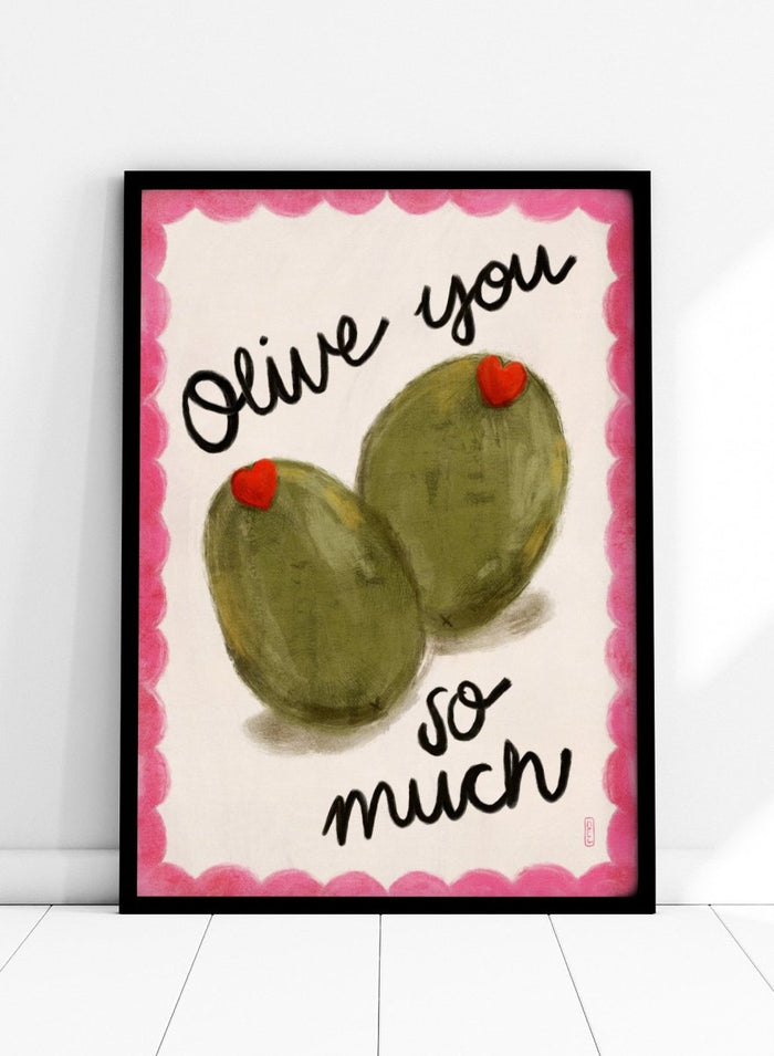 Two olives with red hearts and text 'Olive you so much' on a pink and white background. Olive You So Much by Dirkie Nell is a playful food art print featuring hand painted olives, pink accents, handwritten typography, and whimsical kitchen art details.