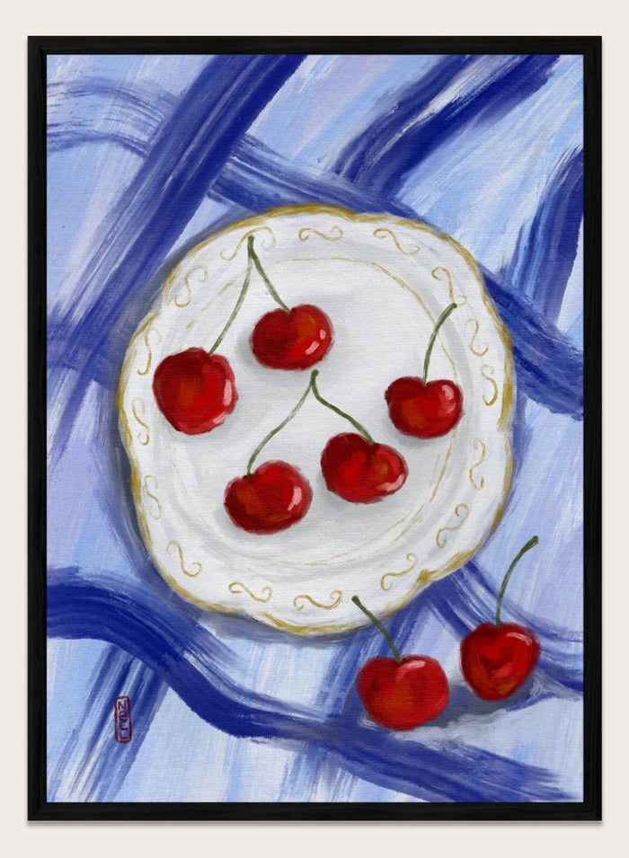 Painting of cherries on a white plate with a blue background. Red Cherries Blue Table by Dirkie Nell is a contemporary fruit still life art print featuring hand painted cherries, blue table linens, and colorful kitchen wall art style.