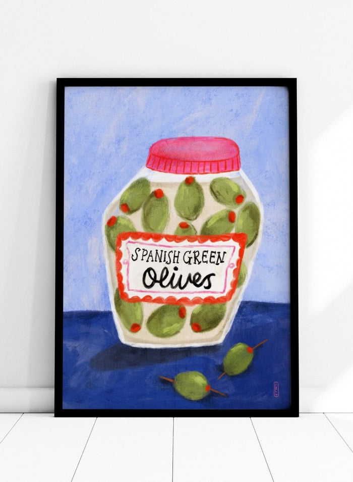 Illustration of a jar of Spanish green olives on a blue background. Spanish Green Olives Jar by Dirkie Nell is a playful food art print featuring hand painted olives, colorful kitchen details, and Mediterranean inspired design.