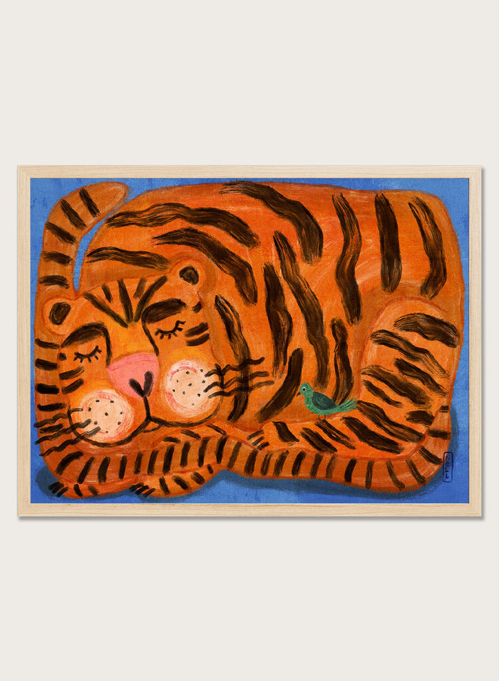A framed painting of a sleeping tiger on a blue background. The tiger is orange with bold black stripes, has a pink nose and cheeks, and a small green bird near its side. A framed painting of a sleeping tiger on a blue background. The tiger is orange with bold black stripes, has a pink nose and cheeks, and a small green bird near its side.