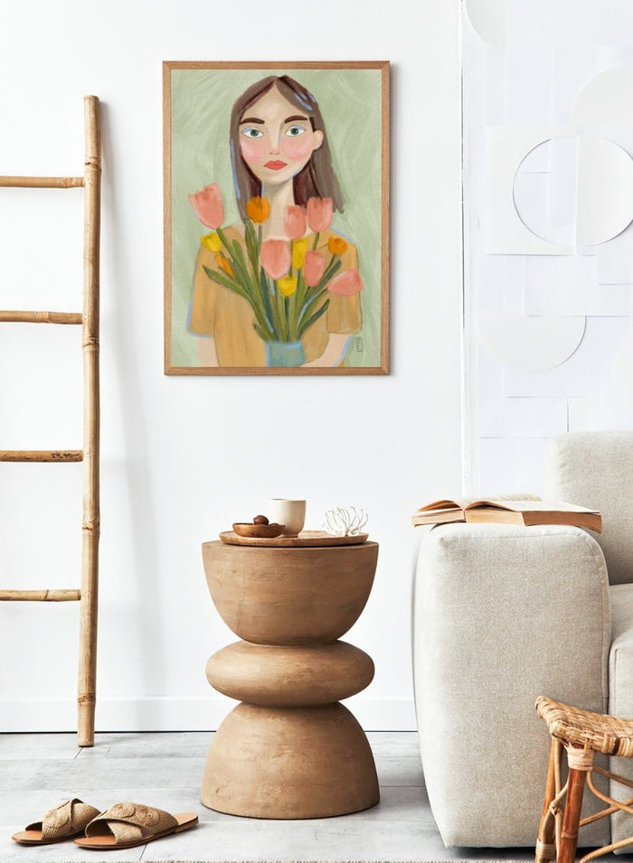 Artistic illustration of a woman holding flowers with a soft, pastel background. Woman with Spring Tulips by Dirkie Nell is a contemporary floral portrait art print featuring hand painted tulips, expressive illustration, and soft spring colors.