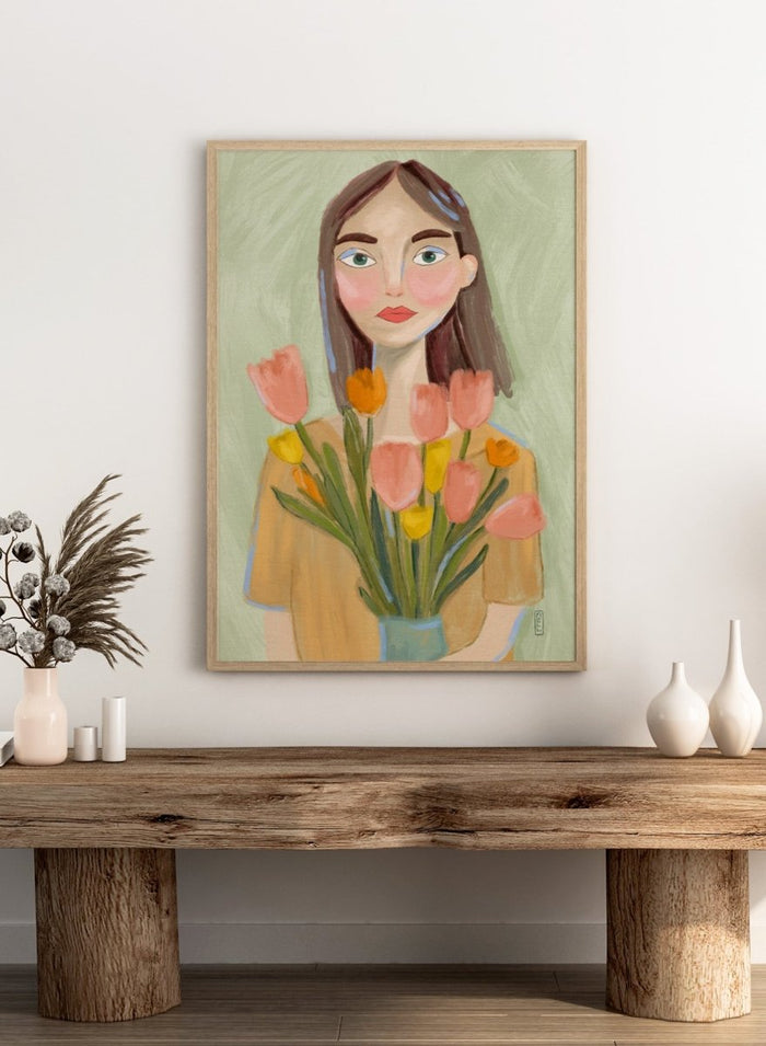 Artistic illustration of a woman holding flowers with a soft, pastel background. Woman with Spring Tulips by Dirkie Nell is a contemporary floral portrait art print featuring hand painted tulips, expressive illustration, and soft spring colors.