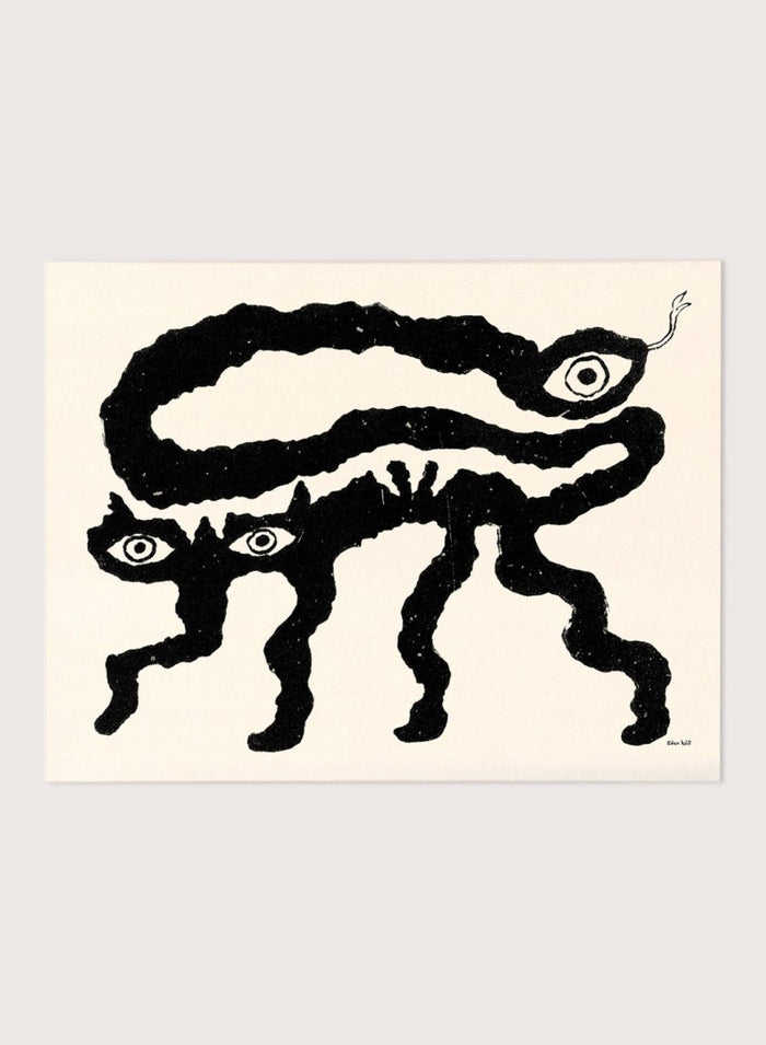 Framed artwork of a black and white creature with cat-like features and snake-like body. I Am Animals by Eden Kalif is a modern minimalist line art print featuring abstract animal forms in a bold black and white contemporary wall poster design.