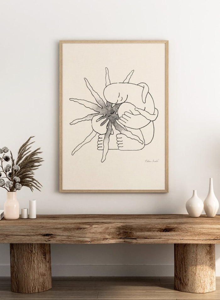 Black and white line art of a person embracing a sun figure on a beige background. Sunshine Love by Eden Kalif is a modern line art print featuring a figure holding a sun in a minimalist contemporary wall poster design.