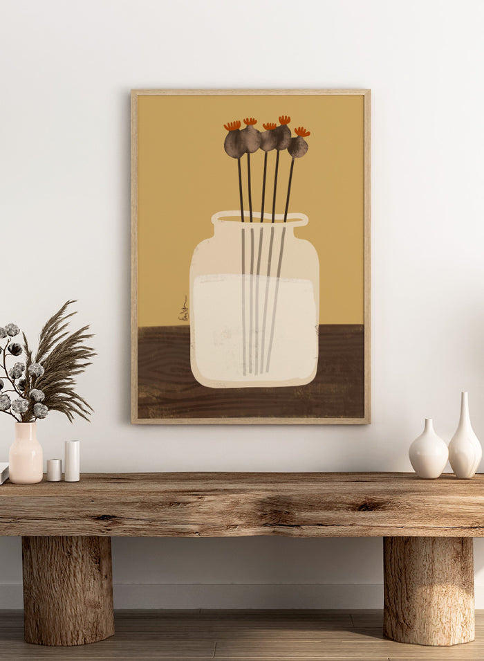 A stylized art print depicting a white glass jar filled with water, holding four dried poppy pods with orange tops, set against a warm tan background and a dark brown wooden surface. Shop Dried Poppy Pods Vase by Elsa Nätterdal, a botanical still life art print featuring dried poppy pods, a cream vase, and warm autumn tones.
