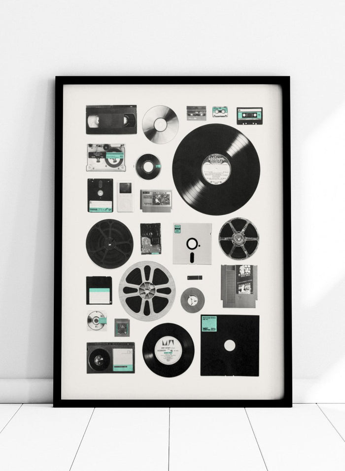 Collection of vintage audio and video equipment on a white background. Analog Digital Memories by Florent Bodart is a retro media art print featuring vinyl, cassette, and floppy disks, a modern wall poster exploring analog and digital design.