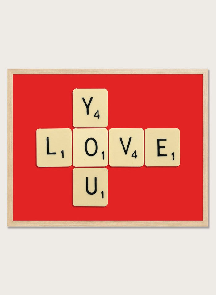 Scrabble tiles spelling LOVE YOU on a red background. Love You by Florent Bodart is a playful crossword-style art print featuring letter tiles spelling LOVE YOU on a red background. Retro typography wall poster with optional framing.