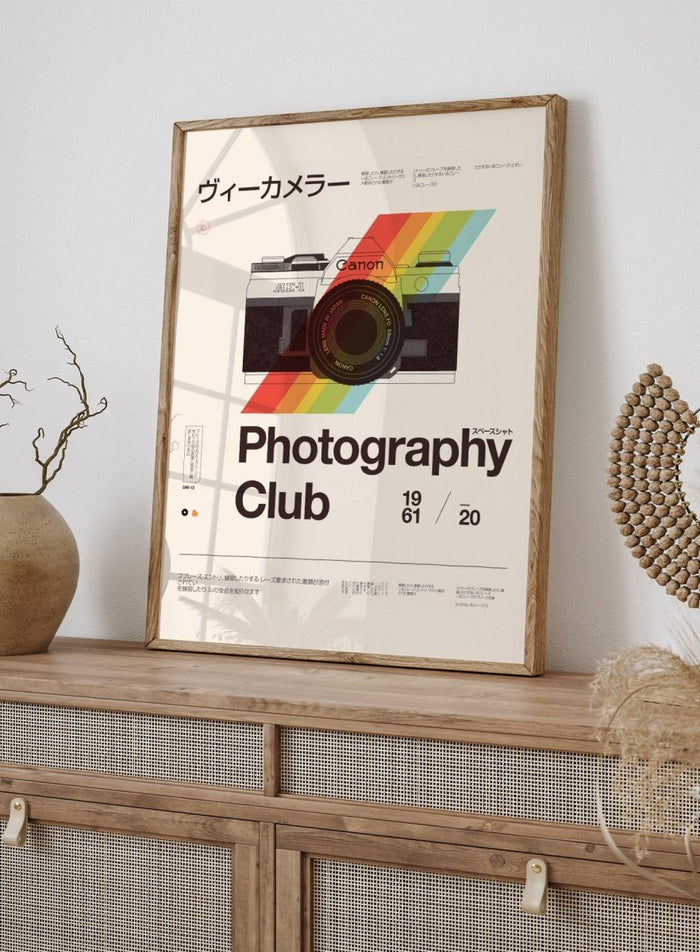 Poster of a camera with a rainbow stripe and text about a photography club. Retro Photography Club by Florent Bodart is a vintage camera art print with bold color and typography, a modern retro wall poster inspired by classic photography design.