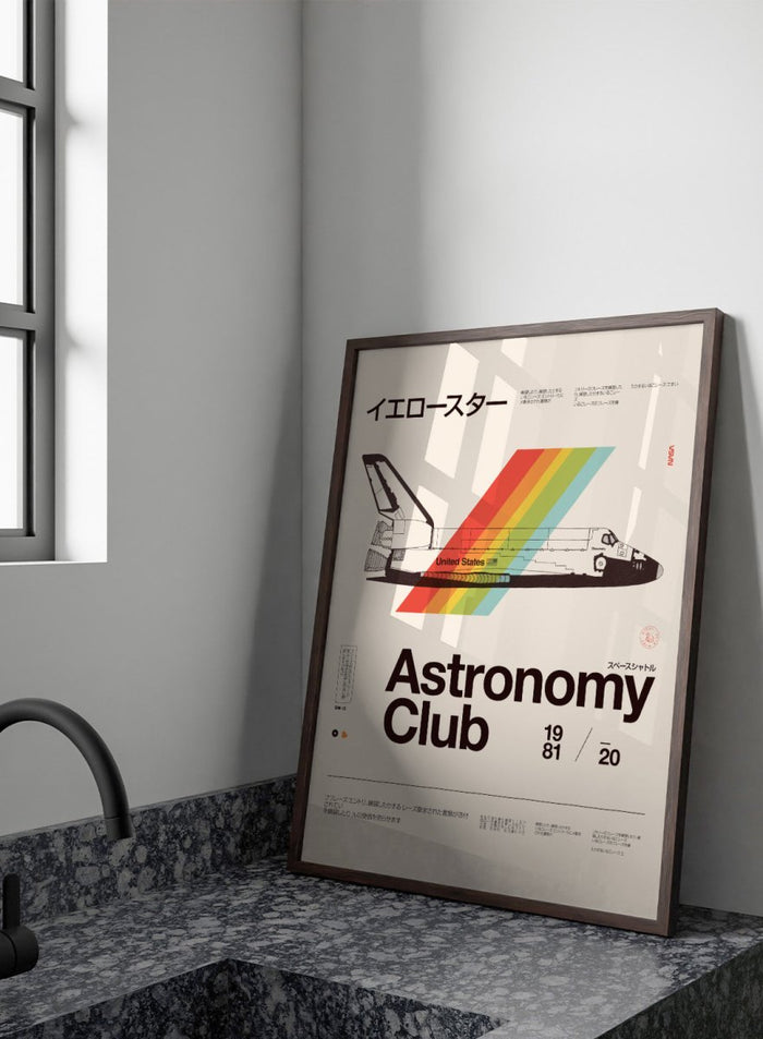 Poster of a space shuttle with a rainbow trail and 'Astronomy Club' text on a beige background. Retro Space Shuttle Rainbow by Florent Bodart is a vintage space art print with bold color stripes, a modern retro wall poster inspired by space and graphic design.
