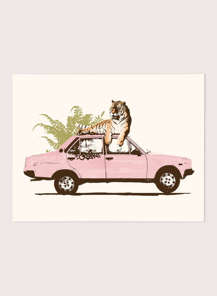 Framed artwork of a tiger in a pink car with greenery on a white background. Tiger On Pink Car by Florent Bodart is a surreal animal art print with a tiger on a vintage car, a modern wall poster with playful, bold, and imaginative design.