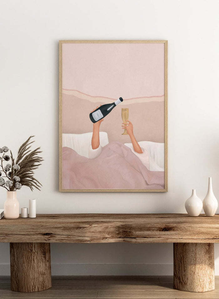 Illustration of a person lying in bed holding a bottle and a glass, with a soft pink background. Champagne In Bed by Flow Line is a playful bedroom art print featuring champagne, pink bedding, and slow mornings, perfect for modern and feminine interiors.