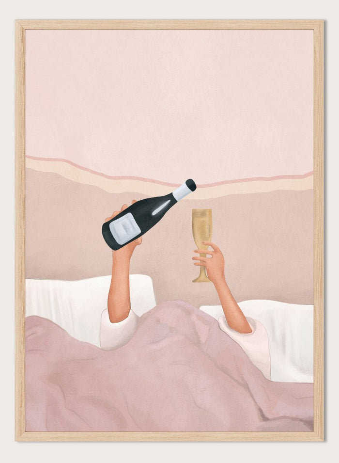 Illustration of a person lying in bed holding a bottle and a glass, with a soft pink background. Champagne In Bed by Flow Line is a playful bedroom art print featuring champagne, pink bedding, and slow mornings, perfect for modern and feminine interiors.