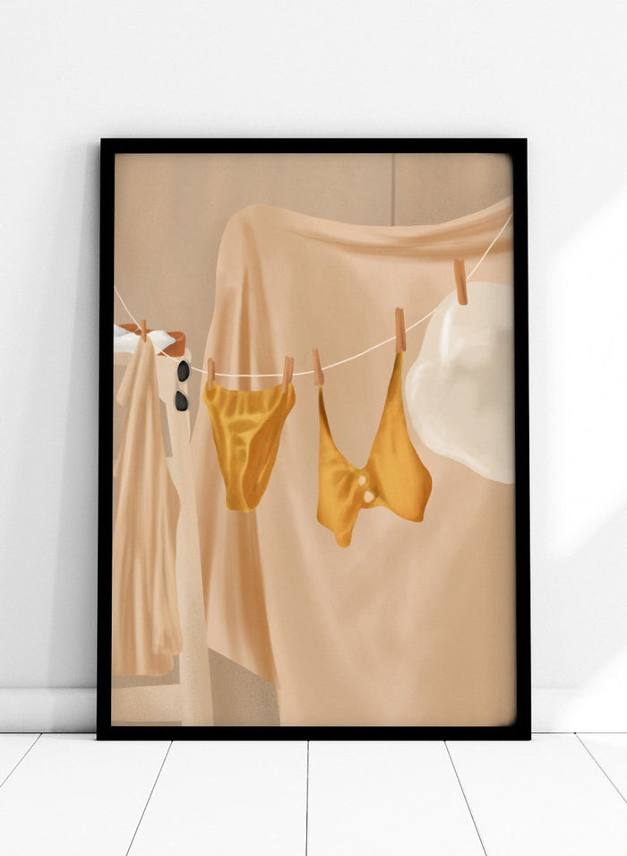 Yellow bikini top and bottom hanging on a clothesline against a beige background. Golden Summer Laundry by Flow Line is a summer art print featuring hanging linens, a yellow swimsuit, sun hat, and Mediterranean-inspired coastal decor.
