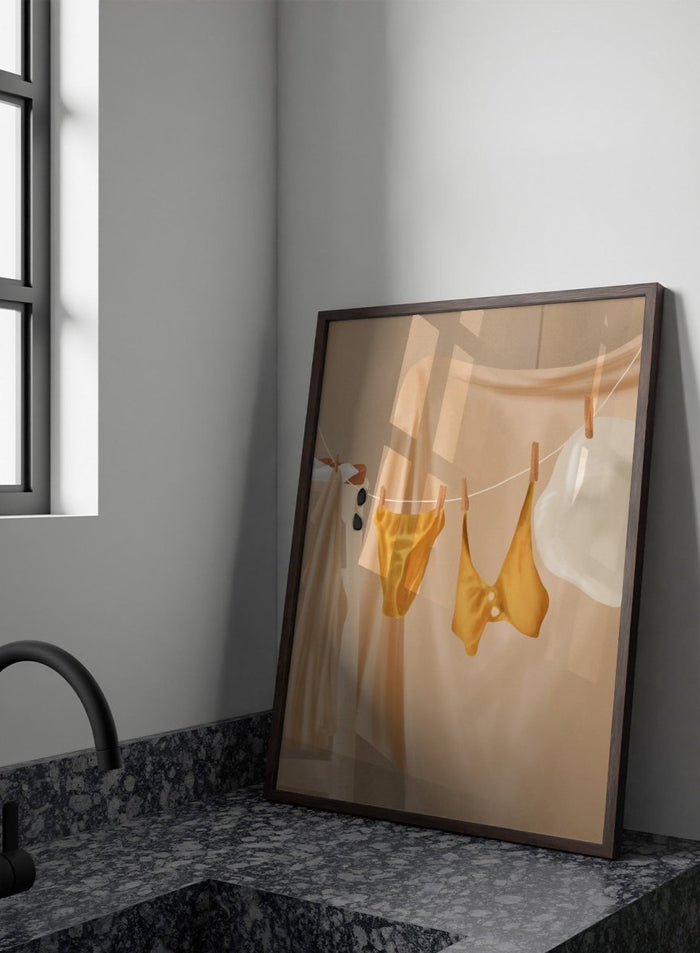 Yellow bikini top and bottom hanging on a clothesline against a beige background. Golden Summer Laundry by Flow Line is a summer art print featuring hanging linens, a yellow swimsuit, sun hat, and Mediterranean-inspired coastal decor.