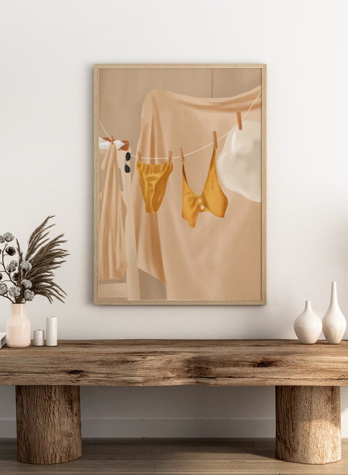 Yellow bikini top and bottom hanging on a clothesline against a beige background. Golden Summer Laundry by Flow Line is a summer art print featuring hanging linens, a yellow swimsuit, sun hat, and Mediterranean-inspired coastal decor.