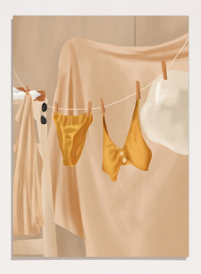 Yellow bikini top and bottom hanging on a clothesline against a beige background. Golden Summer Laundry by Flow Line is a summer art print featuring hanging linens, a yellow swimsuit, sun hat, and Mediterranean-inspired coastal decor.