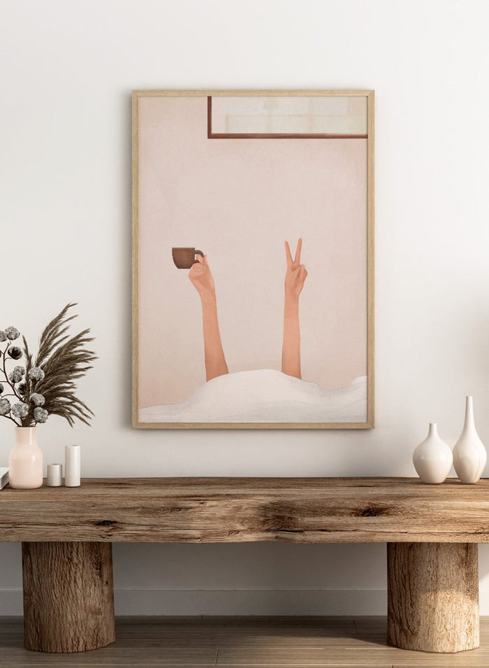Person holding a cup with one hand and making a peace sign with the other, against a plain wall. Morning Coffee Peace by Flow Line is a playful coffee art print featuring a cozy bed scene, slow mornings, and minimalist bedroom wall art for modern interiors.