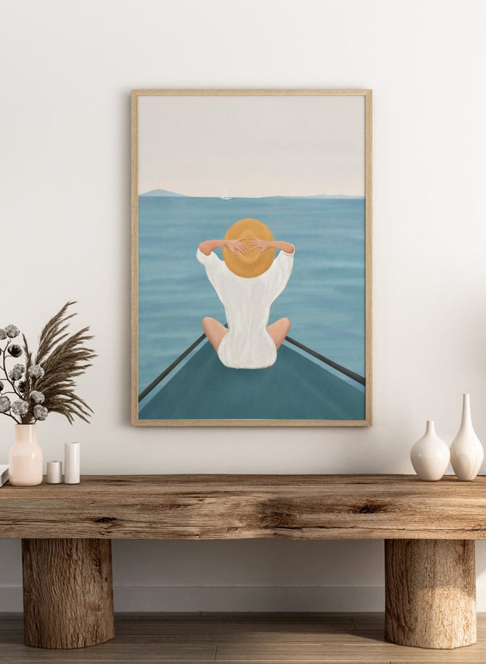 Person sitting on a dock over water wearing a white dress and straw hat. Ocean Escape by Flow Line features a woman sitting on a boat overlooking the sea, creating a coastal art print inspired by travel, summer, and ocean living.