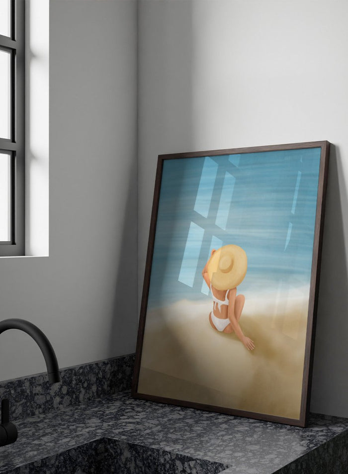 Woman in a white bikini and sun hat sitting on sand looking at ocean. Ocean View Relaxation by Flow Line is a coastal wall art print featuring a woman by the ocean, soft blue tones, beach decor, and relaxed summer style.