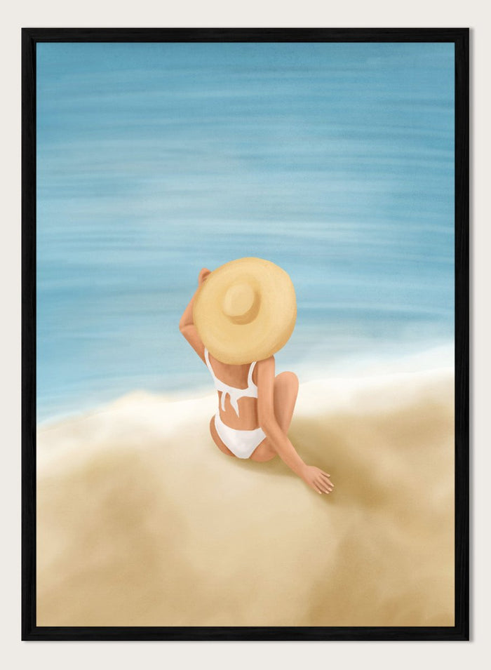 Woman in a white bikini and sun hat sitting on sand looking at ocean. Ocean View Relaxation by Flow Line is a coastal wall art print featuring a woman by the ocean, soft blue tones, beach decor, and relaxed summer style.