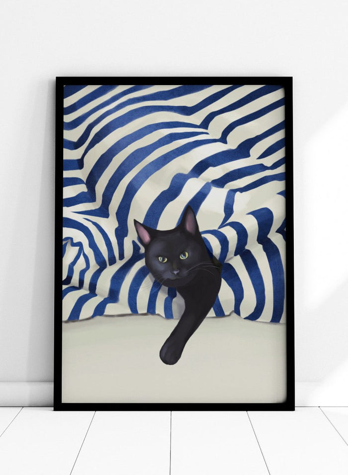 Black cat peeking out from behind a blue and white striped fabric. Peeking Black Cat by Flow Line features a mischievous black cat among striped cushions, adding playful cat art and modern coastal style to your home.