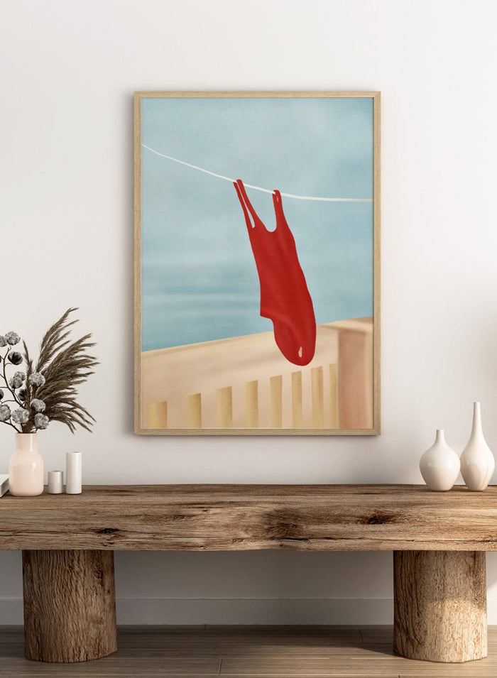 Red swimsuit hanging on a clothesline against a blue sky. Red Swimsuit On Balcony by Flow Line features a red swimsuit drying in the sun, bringing Mediterranean charm and summer vacation style to your walls.