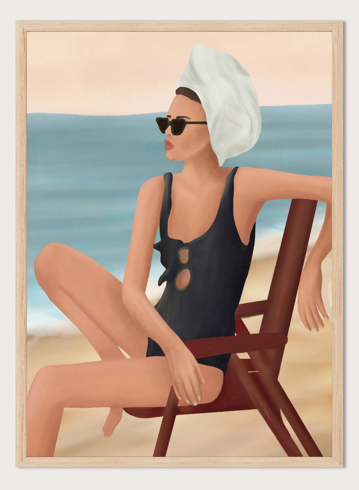 Woman in a black swimsuit with a towel on her head, sitting on a beach chair by the ocean. Relaxed Beach Style by Flow Line features a woman lounging by the sea in vintage swimwear, bringing coastal elegance and summer style to your walls.