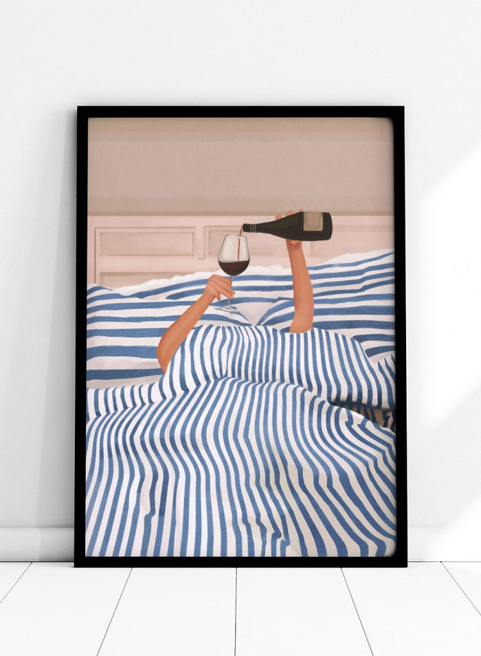 Person lying in bed pouring wine into a glass, wearing striped sheets. Wine In Bed by Flow Line is a playful art print featuring striped bedding, red wine, minimalist illustration, and cozy bedroom decor.