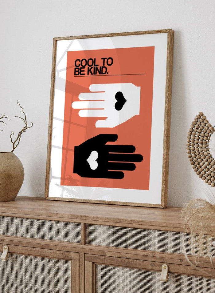 Poster with two hands reaching towards each other, one white and one black, on an orange background with 'Cool to be kind' text. Cool To Be Kind by Frances Collett is a modern kindness art print featuring two graphic hands with heart symbols. Officially licensed contemporary wall poster with optional framing.