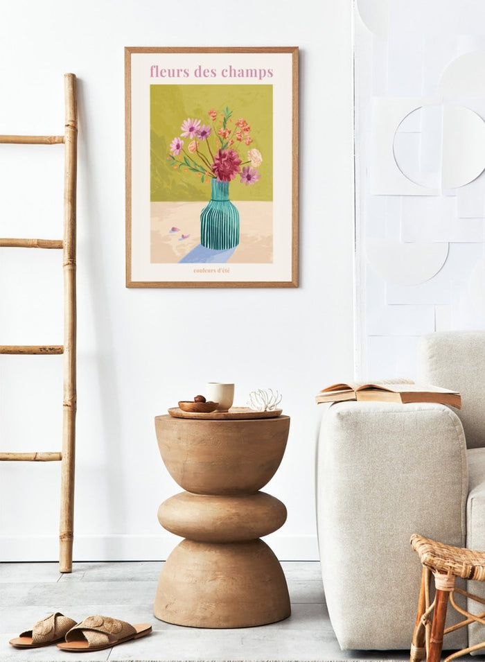 Illustration of a vase with flowers on a green background, featuring the text 'fleurs des champs' and 'couleurs d'ete'. Fleur Des Champs Green by Goed Blauw is a colorful floral art print and wall poster featuring a striped vase with loose flowers on a warm yellow background.