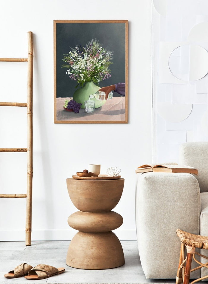 Still life with a green vase of flowers, grapes, and a glass being filled with a bottle. Frivolous Afternoon by Goed Blauw is a modern still life art print and wall poster featuring wildflowers, grapes, and a quiet pouring moment in soft, muted tones.