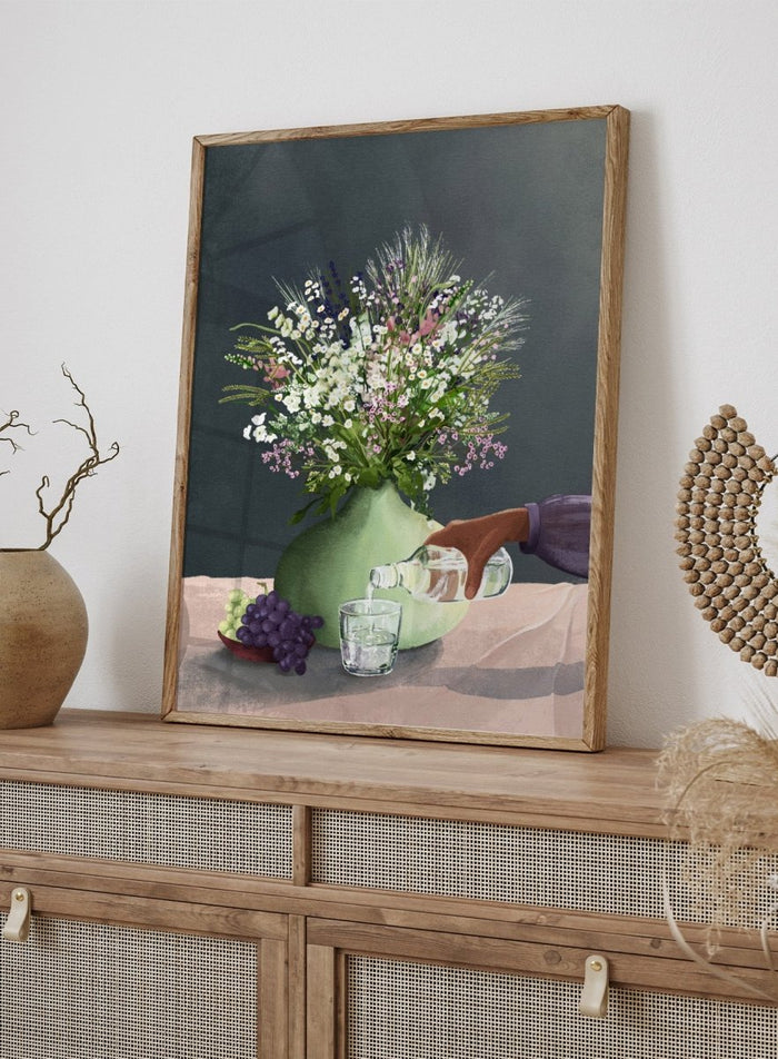 Still life with a green vase of flowers, grapes, and a glass being filled with a bottle. Frivolous Afternoon by Goed Blauw is a modern still life art print and wall poster featuring wildflowers, grapes, and a quiet pouring moment in soft, muted tones.