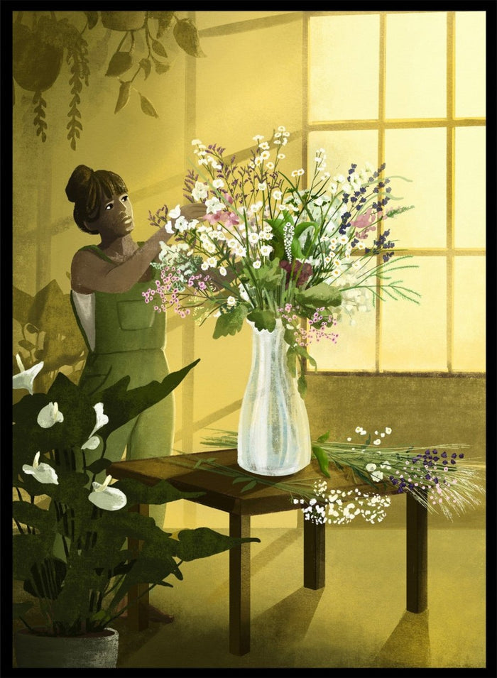 Woman in a green dress holding a bouquet of flowers in a softly lit room. In the Cracks of Light I Dream by Goed Blauw is a floral art print and wall poster featuring a woman arranging flowers in warm window light.