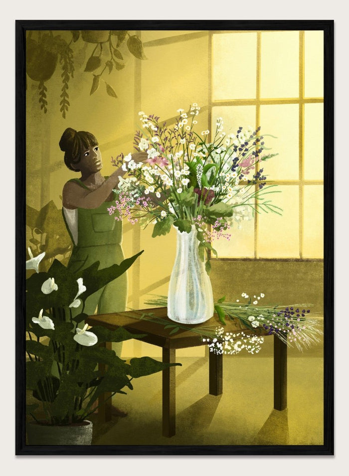 Woman in a green dress holding a bouquet of flowers in a softly lit room. In the Cracks of Light I Dream by Goed Blauw is a floral art print and wall poster featuring a woman arranging flowers in warm window light.