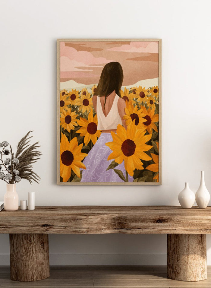 Woman in a white top and purple pants sitting among sunflowers with a scenic background. Sunflower Evenings by Goed Blauw is a fine art print and wall poster featuring a woman standing in a sunflower field with warm golden tones.