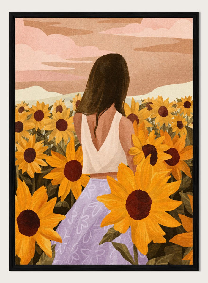 Woman in a white top and purple pants sitting among sunflowers with a scenic background. Sunflower Evenings by Goed Blauw is a fine art print and wall poster featuring a woman standing in a sunflower field with warm golden tones.