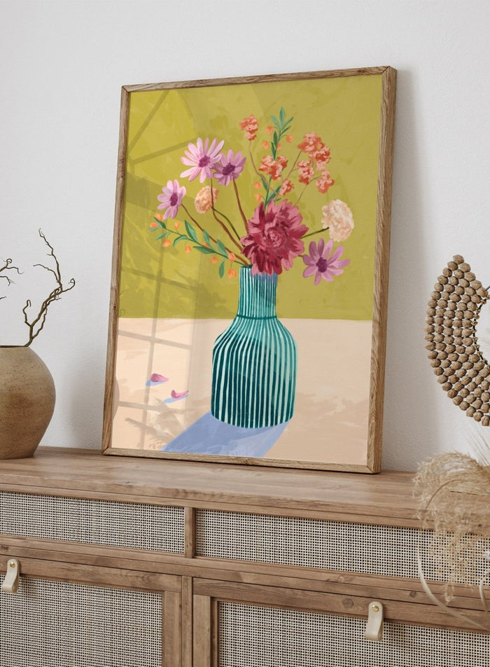 Vase with flowers on a table against a green background. Wildflowers by Goed Blauw is a colorful floral art print and wall poster featuring a striped vase with loose flowers on a warm yellow background.