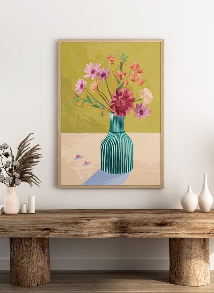 Vase with flowers on a table against a green background. Wildflowers by Goed Blauw is a colorful floral art print and wall poster featuring a striped vase with loose flowers on a warm yellow background.